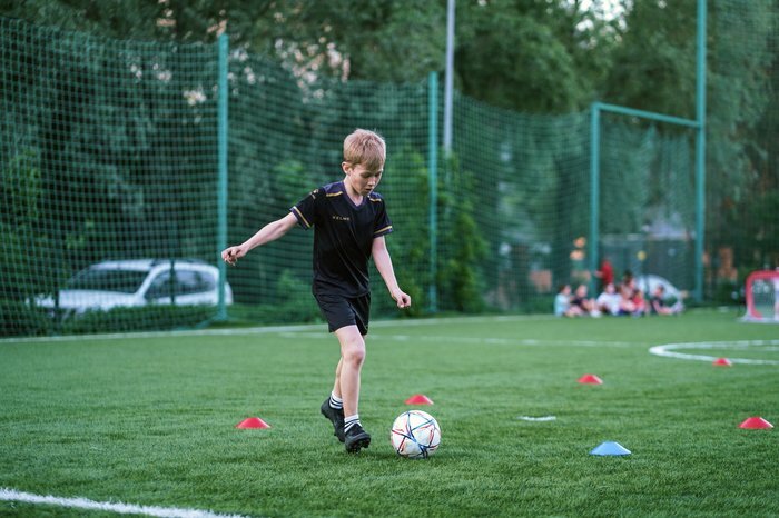 Ребёнок 8-11 лет играет в футбол