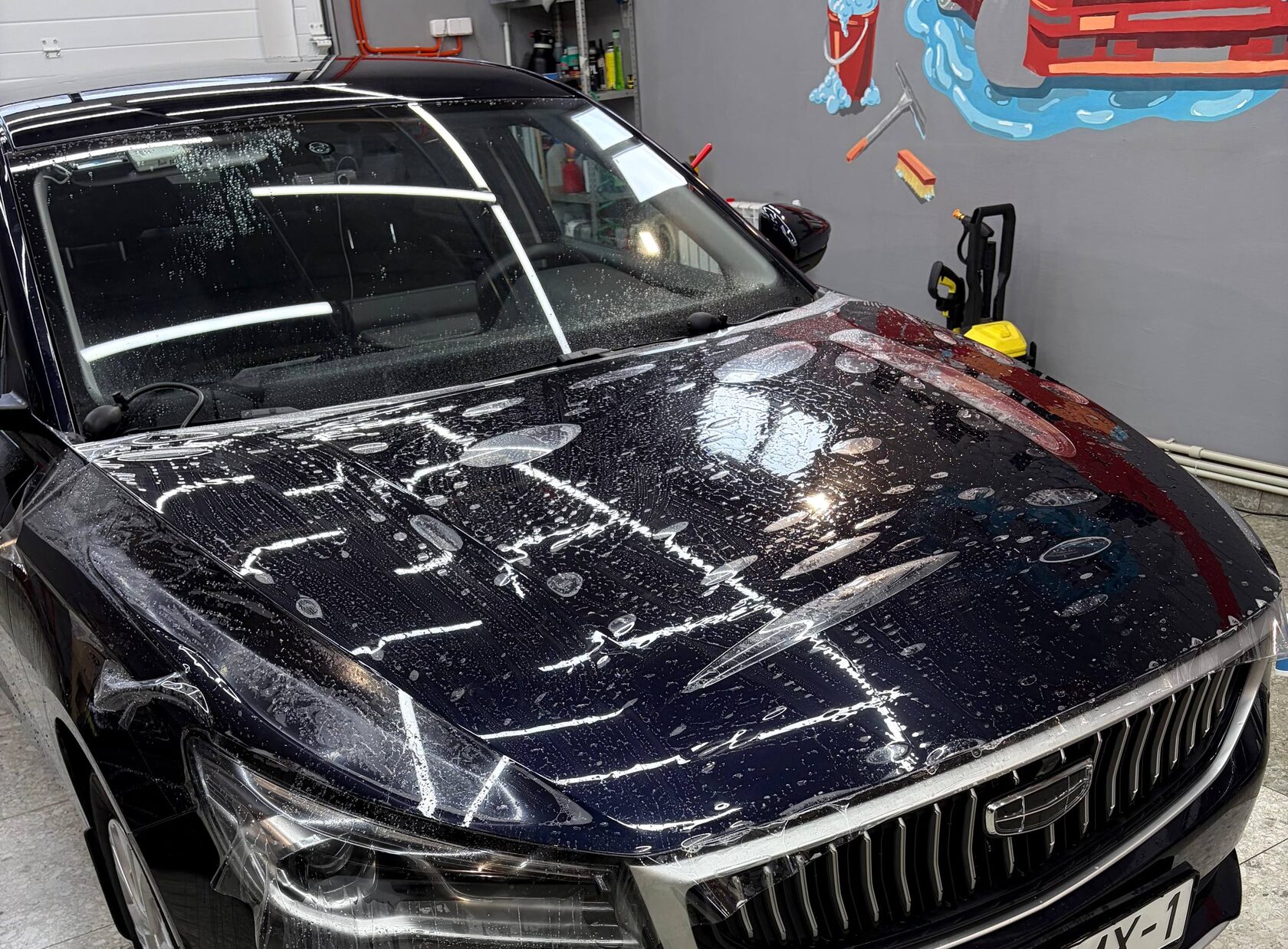Geely с плёнкой на капоте, влажная оклейка