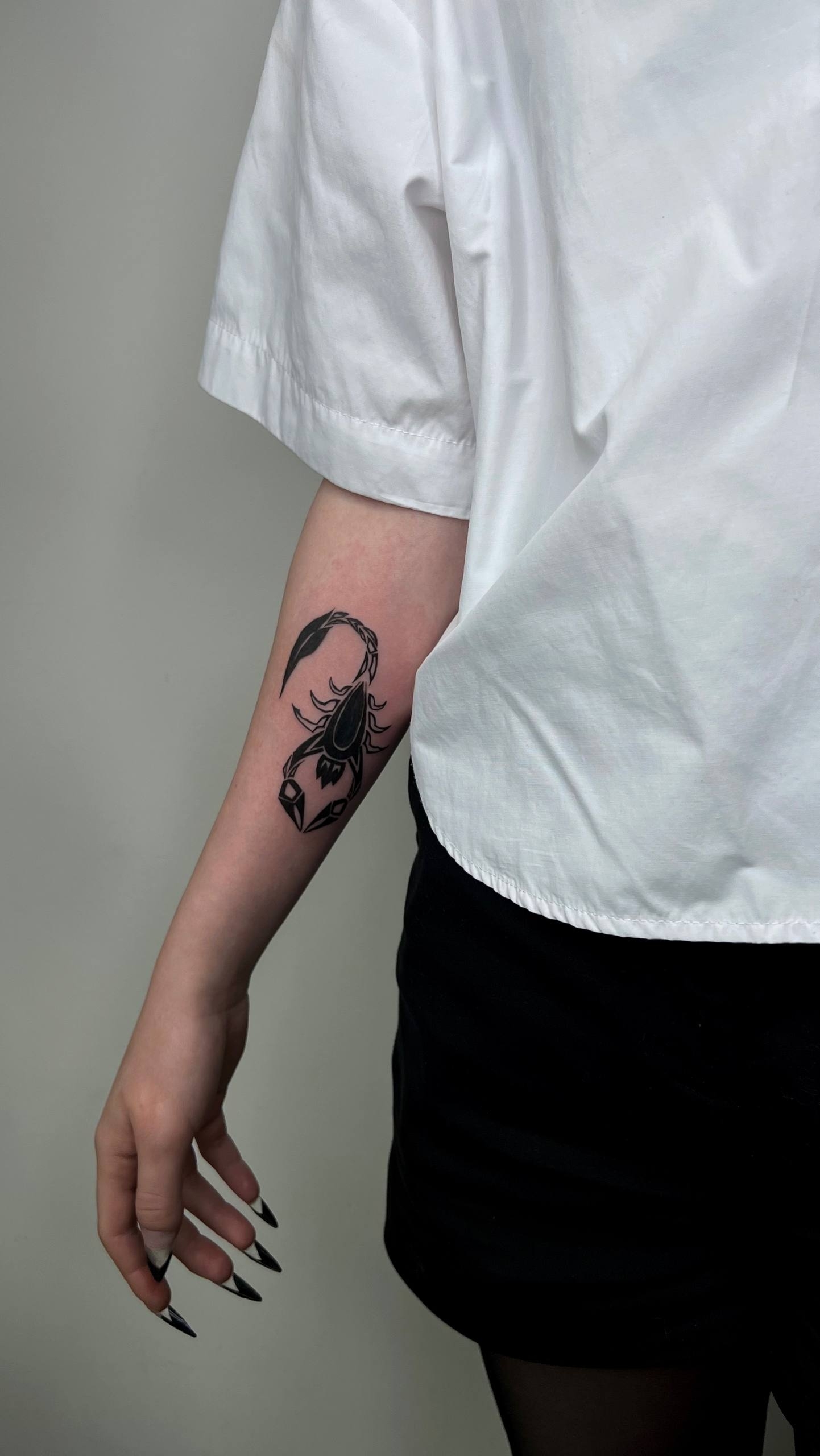 Geometric scorpion tattoo on forearm